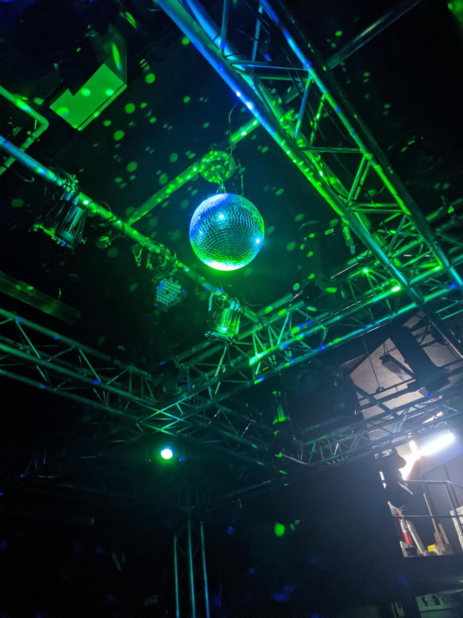 A disco ball shining brightly in a theatre