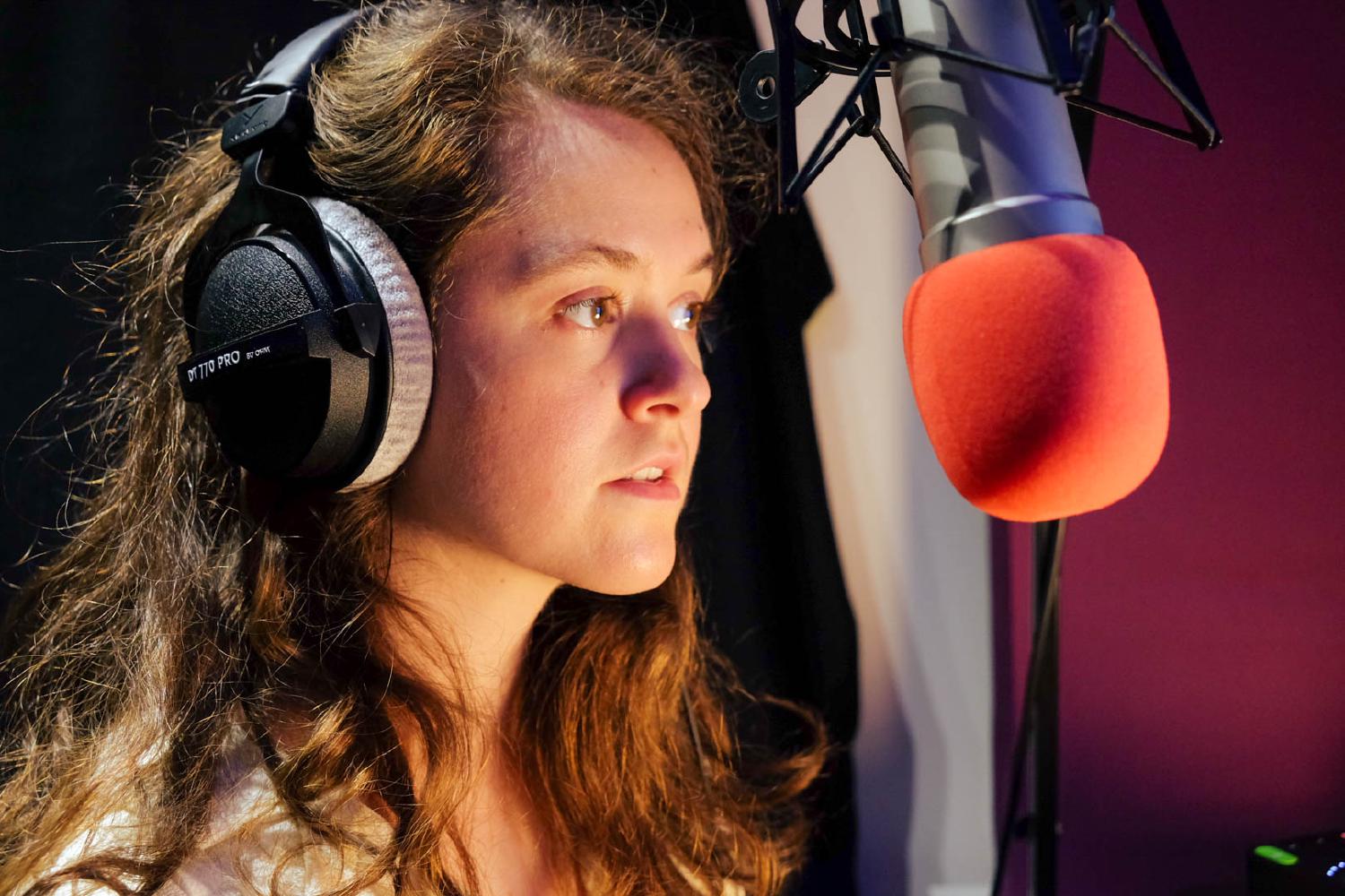 Rae Emily George in her professional home studio recording voiceover